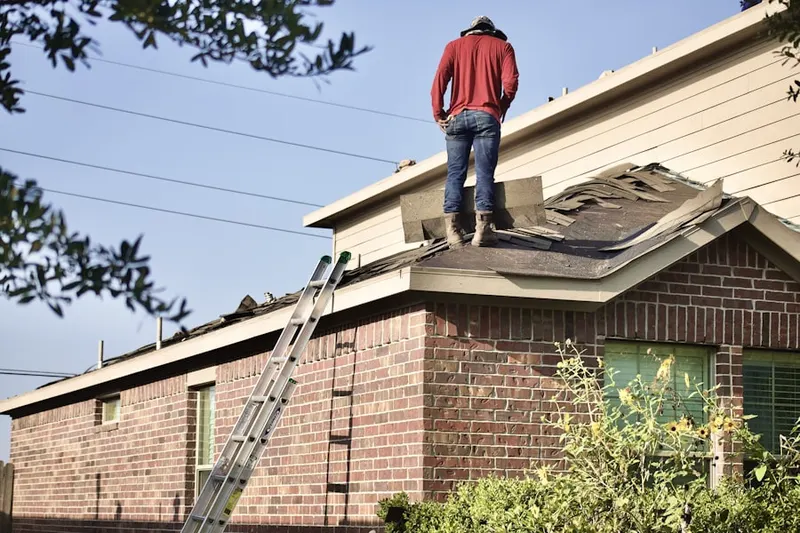 Professional roofer working on a residential roof in Millville